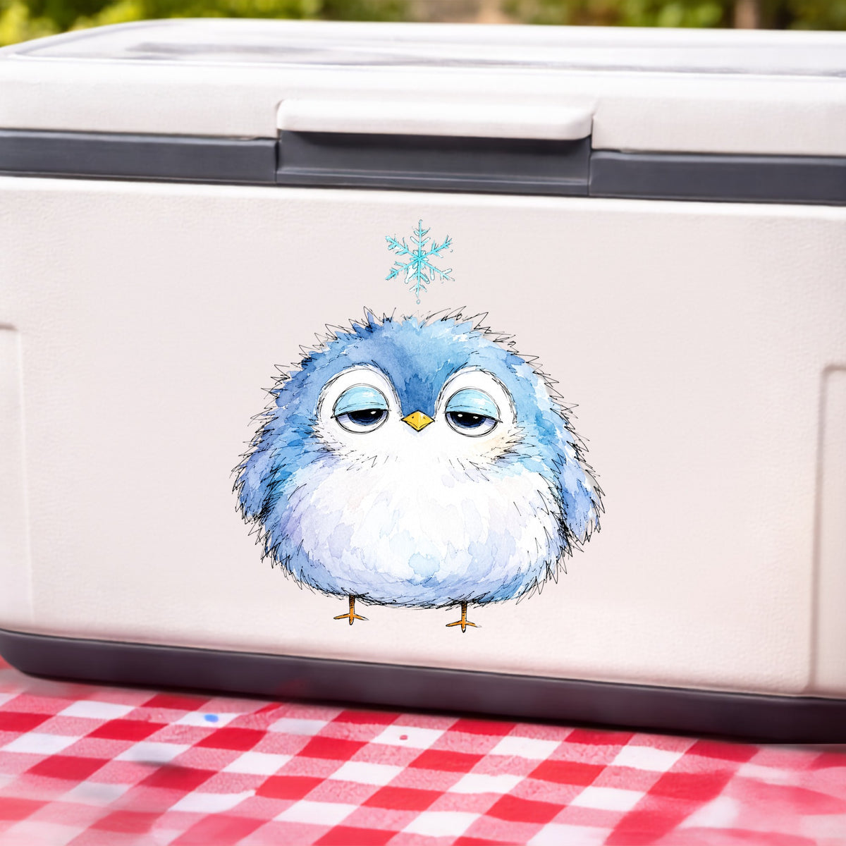 Sleepy Blue Bird Snowflake UV DTF sticker applied to a white cooler on a red gingham cloth
