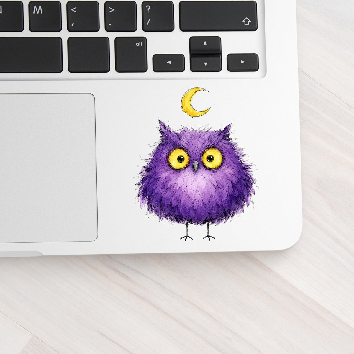 Purple Owl Crescent Moon UV DTF sticker applied to a silver laptop beside the keyboard