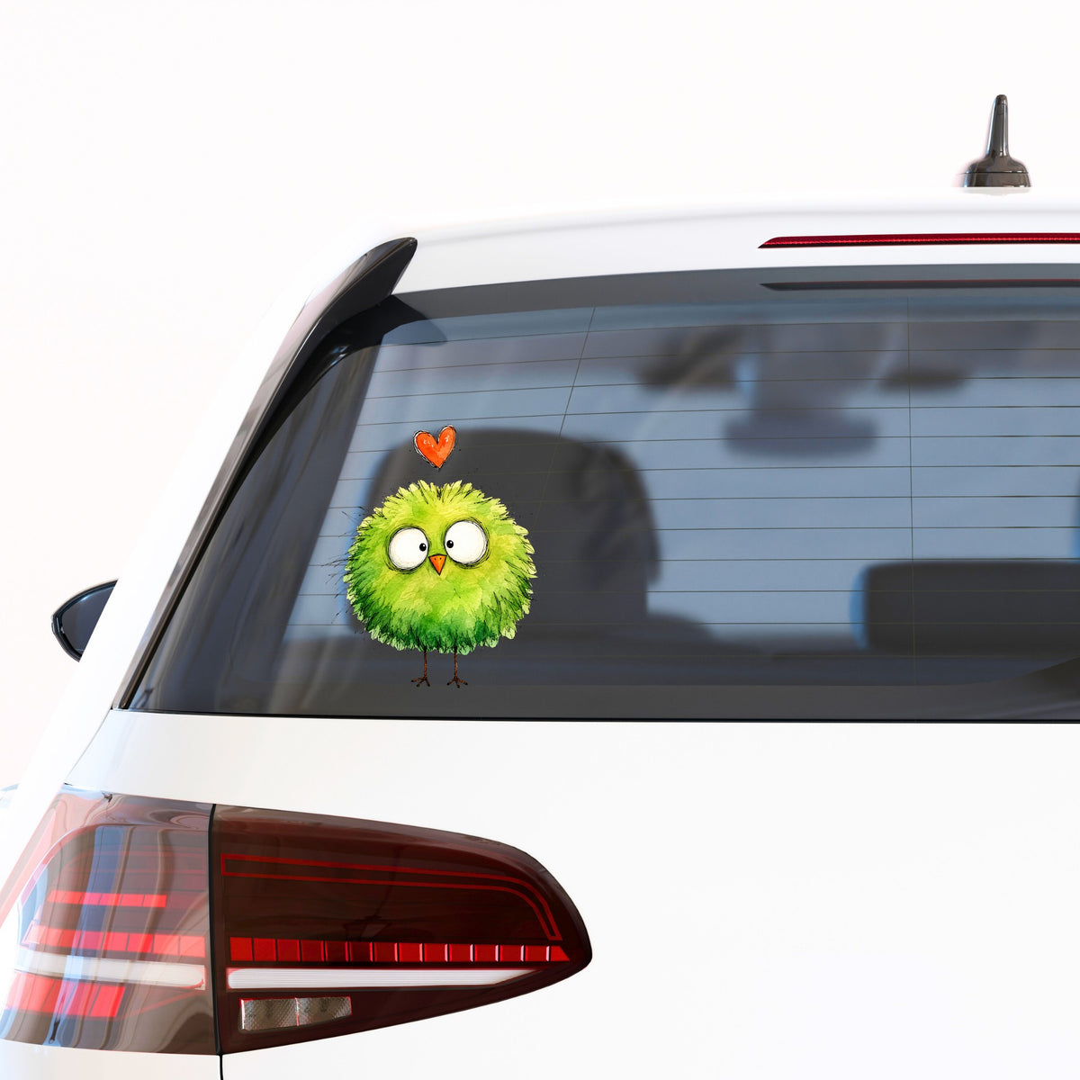 Fluffy Green Bird UV DTF sticker applied to the rear window of a white car