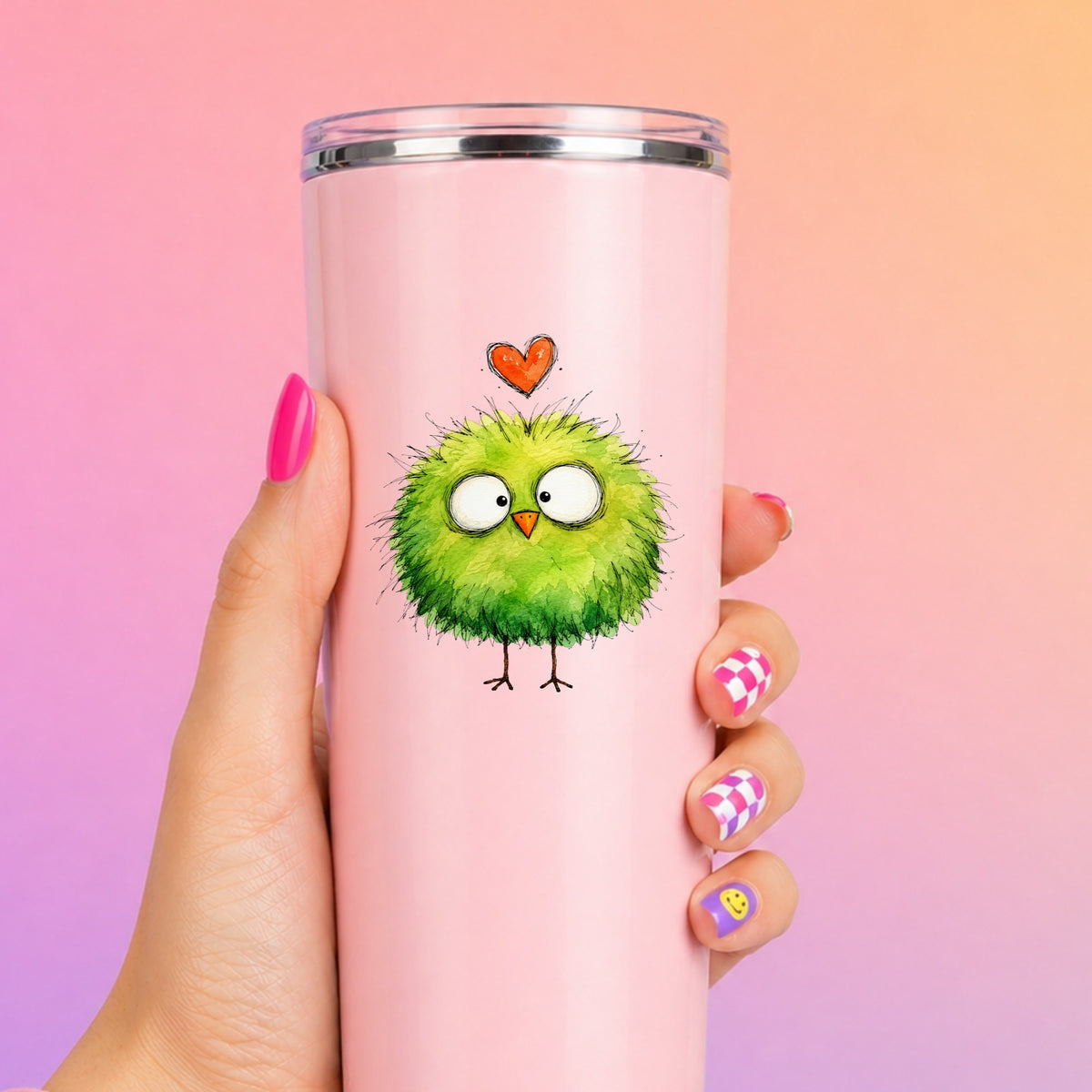 Fluffy Green Bird UV DTF sticker applied to a tall pink tumbler on a pink and orange background