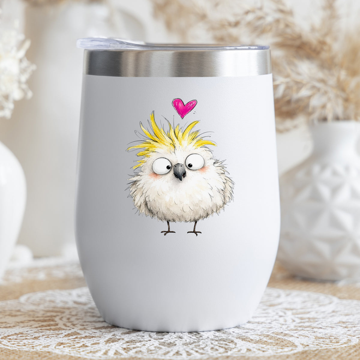Cartoon Cockatoo Parrot UV DTF sticker applied to a white stemless tumbler with a lid