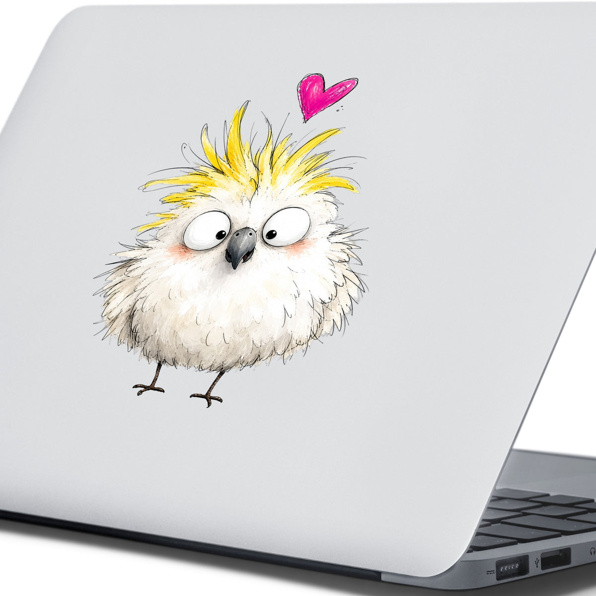Cartoon Cockatoo Parrot UV DTF sticker applied to the lid of a silver laptop