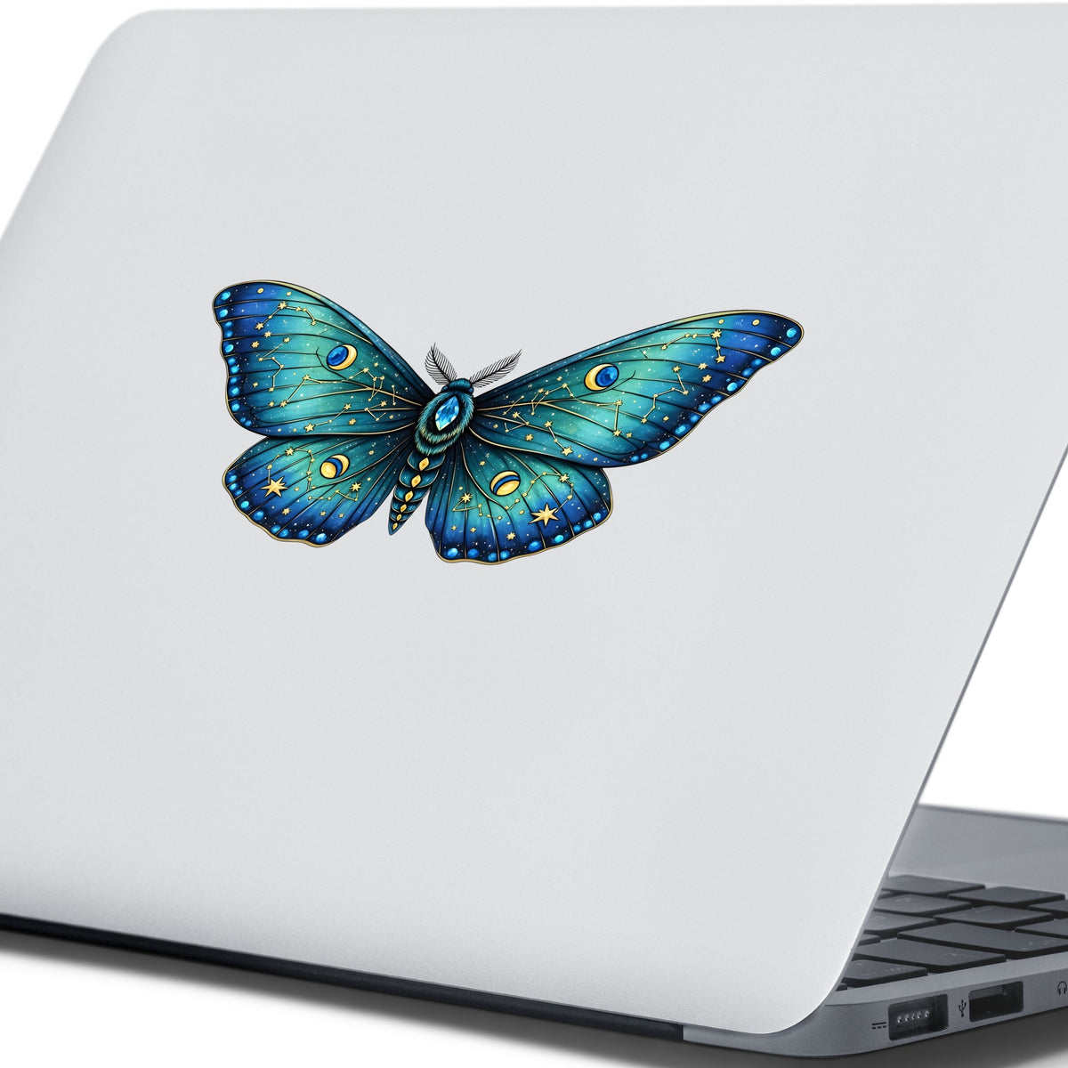 Teal Celestial Moth UV DTF sticker applied to the lid of a silver laptop