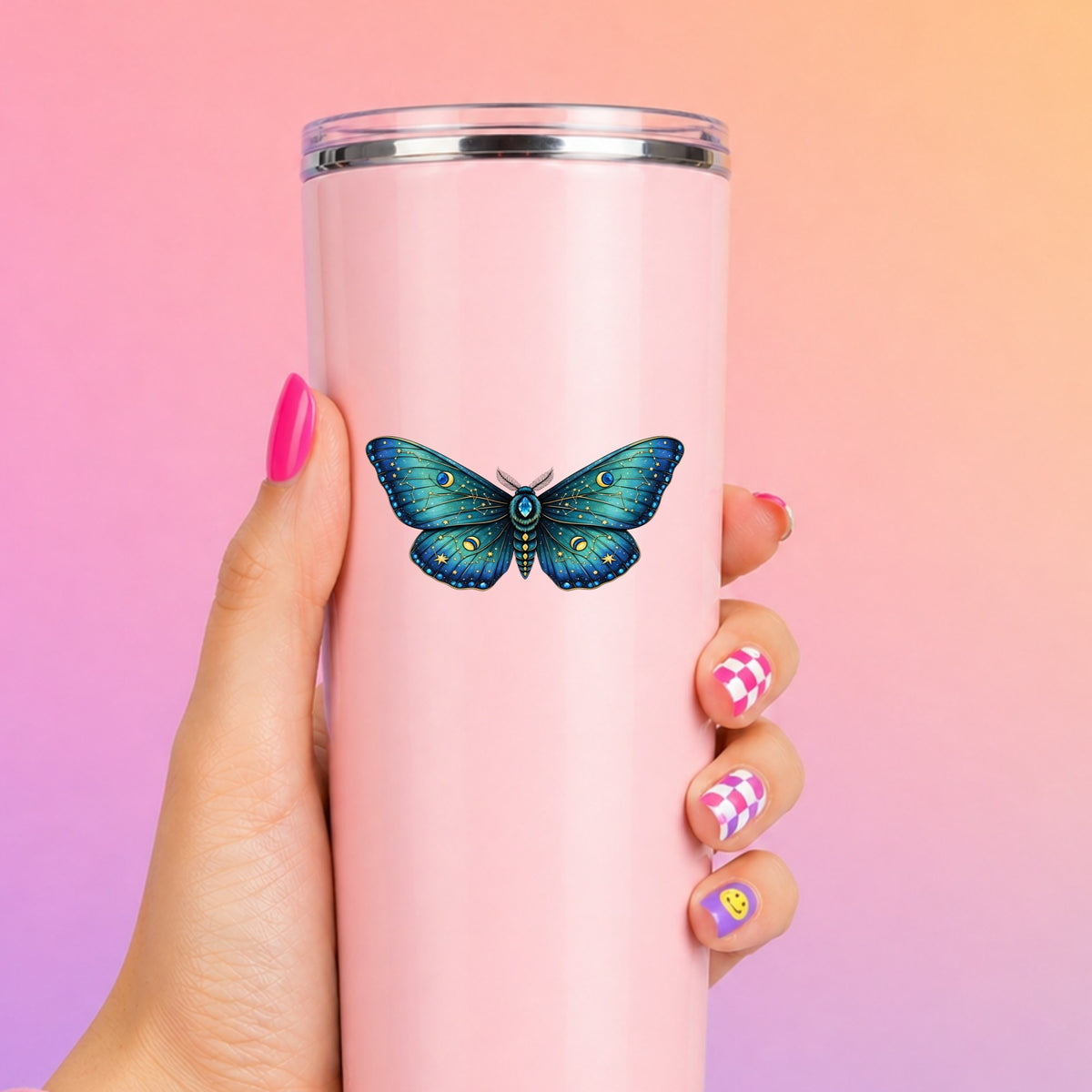 Teal Celestial Moth UV DTF sticker applied to a tall pink tumbler on a pink and orange background