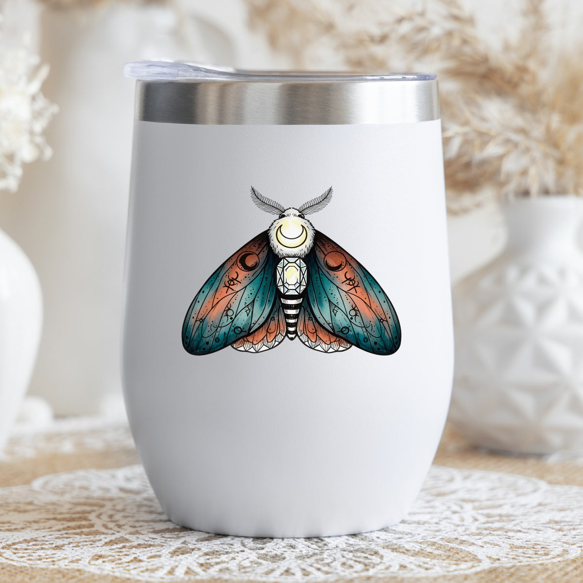 Coral Teal Crescent Moon Moth UV DTF sticker applied to a white stemless tumbler with a lid