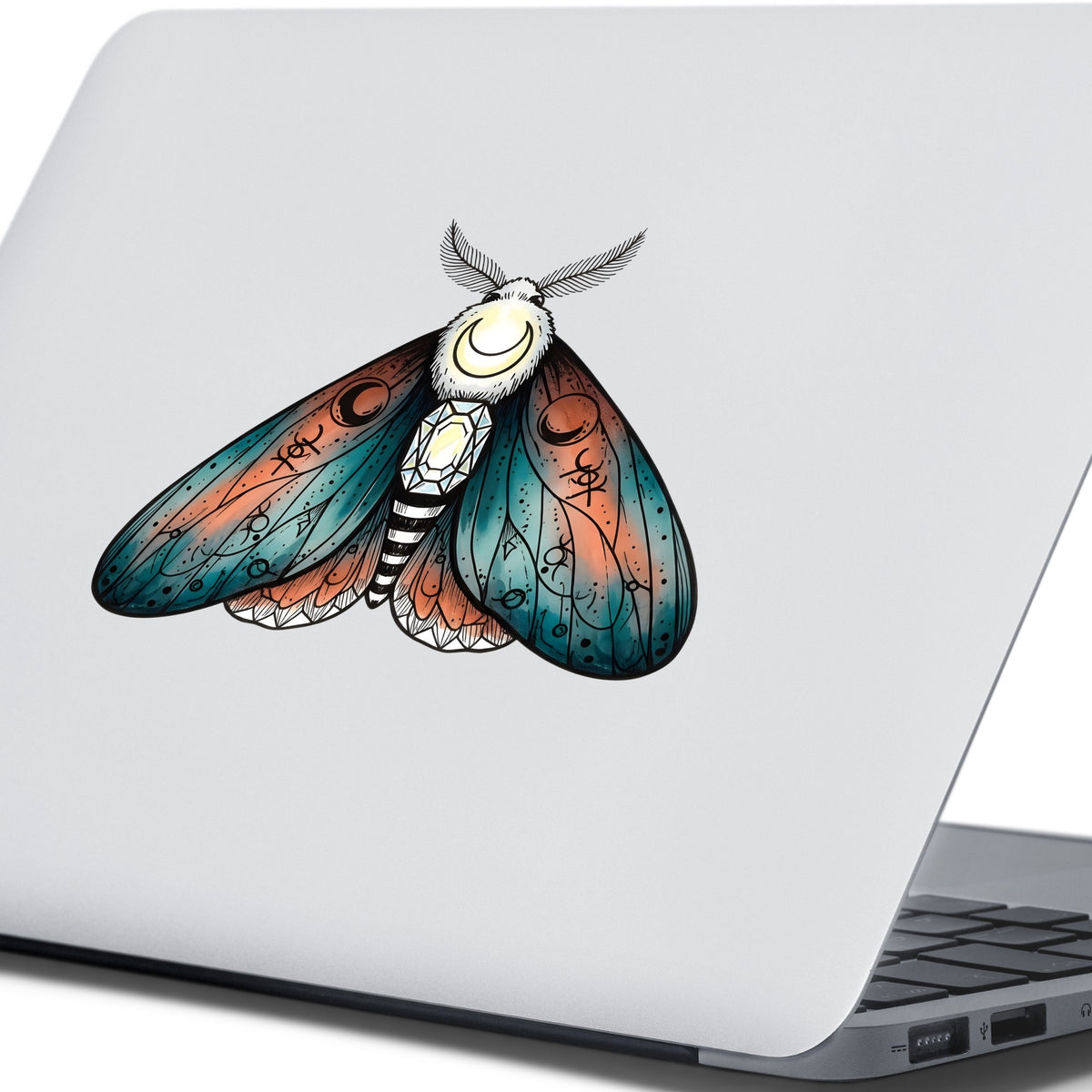 Coral Teal Crescent Moon Moth UV DTF sticker applied to the lid of a silver laptop