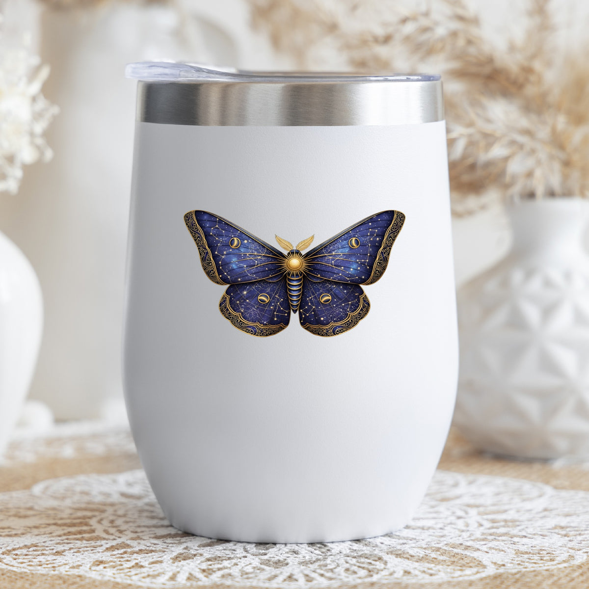 Navy Constellation Moth UV DTF sticker applied to a white stemless tumbler with a lid