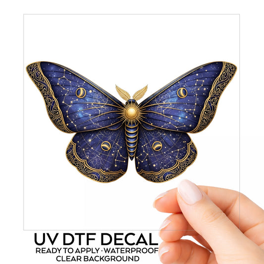 Navy Constellation Moth UV DTF sticker on its backing card, held in hand