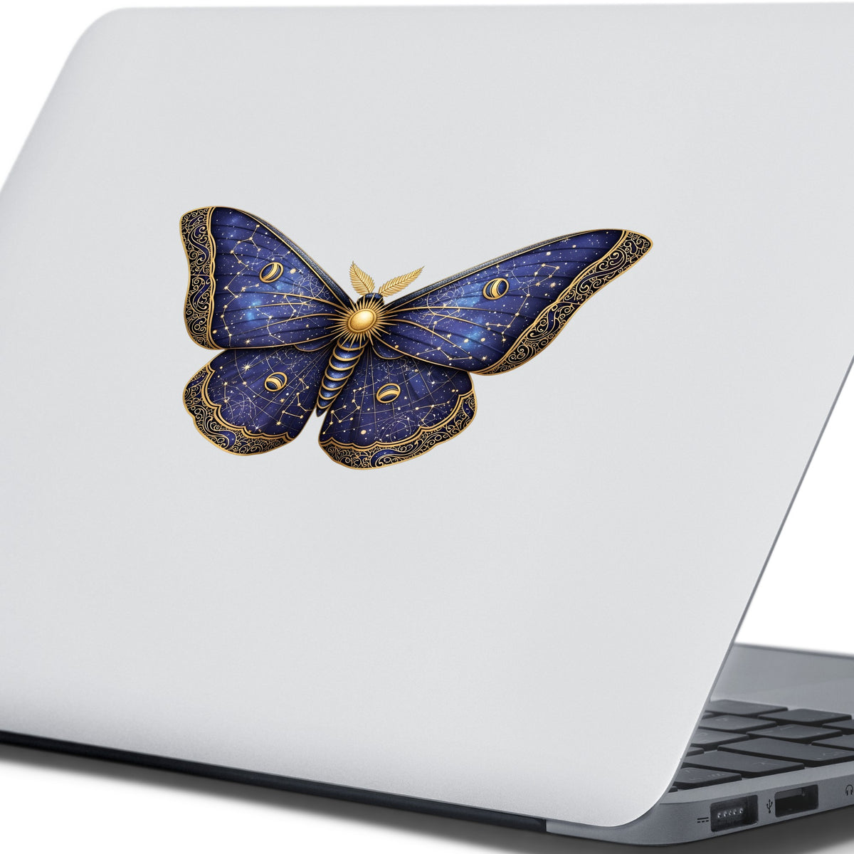 Navy Constellation Moth UV DTF sticker applied to the lid of a silver laptop