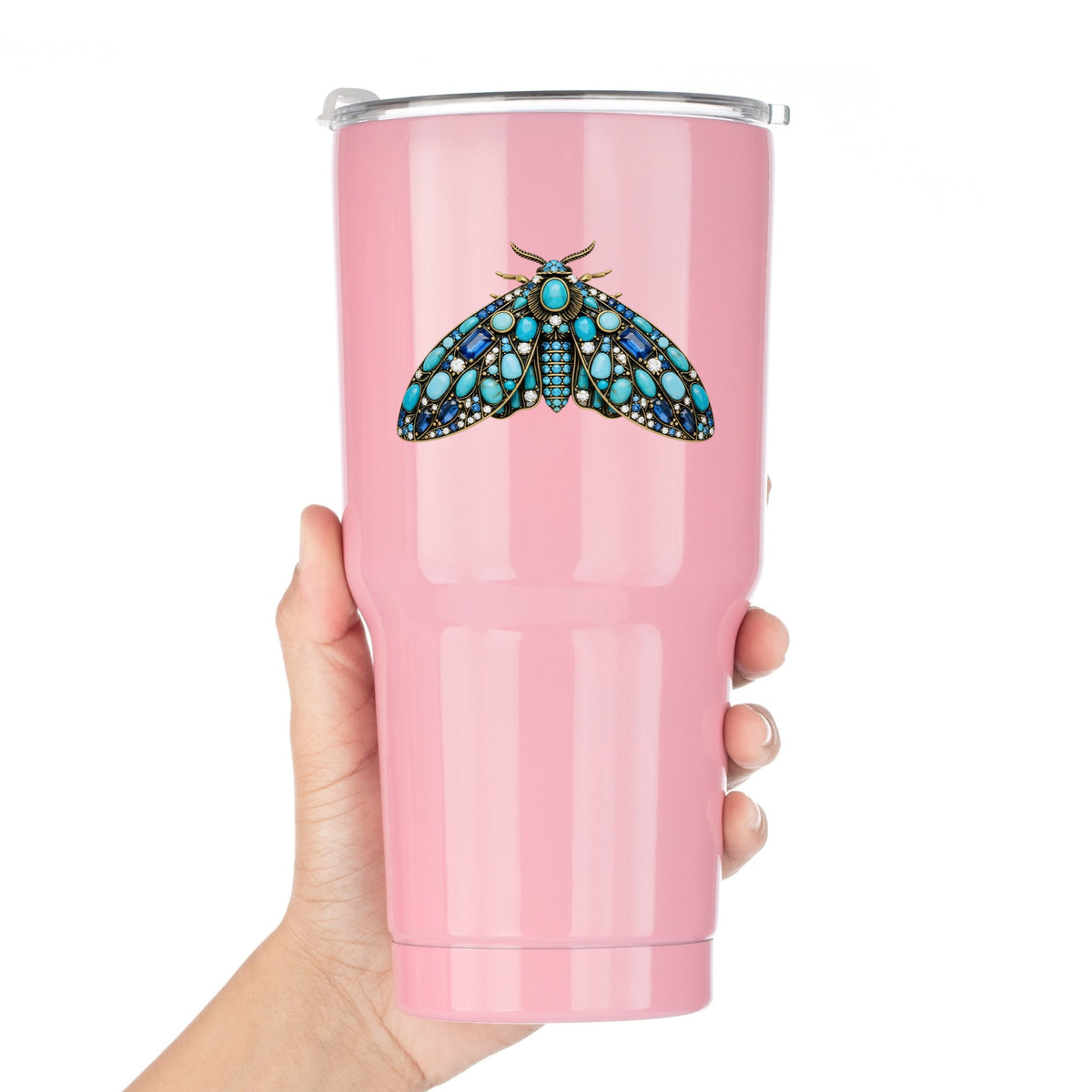 Turquoise Jeweled Moth UV DTF sticker applied to a pink tumbler held against a white background