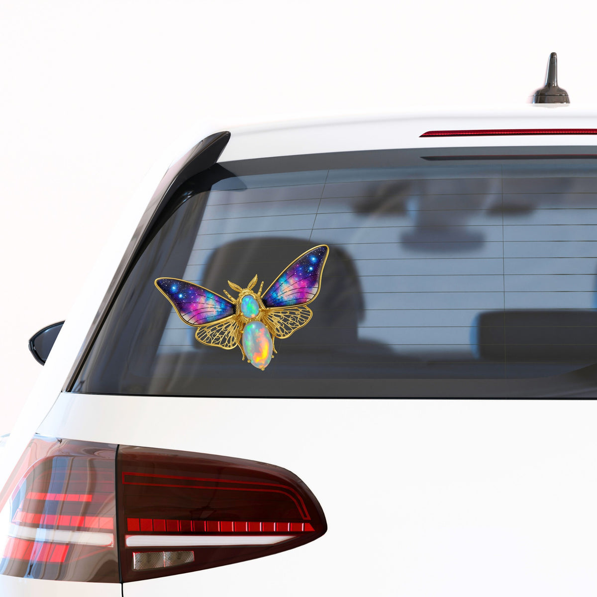 Opal Galaxy Moth UV DTF sticker applied to the rear window of a white car