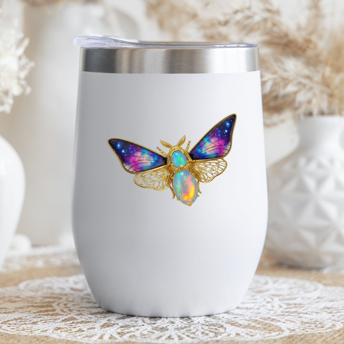 Opal Galaxy Moth UV DTF sticker applied to a white stemless tumbler with a lid