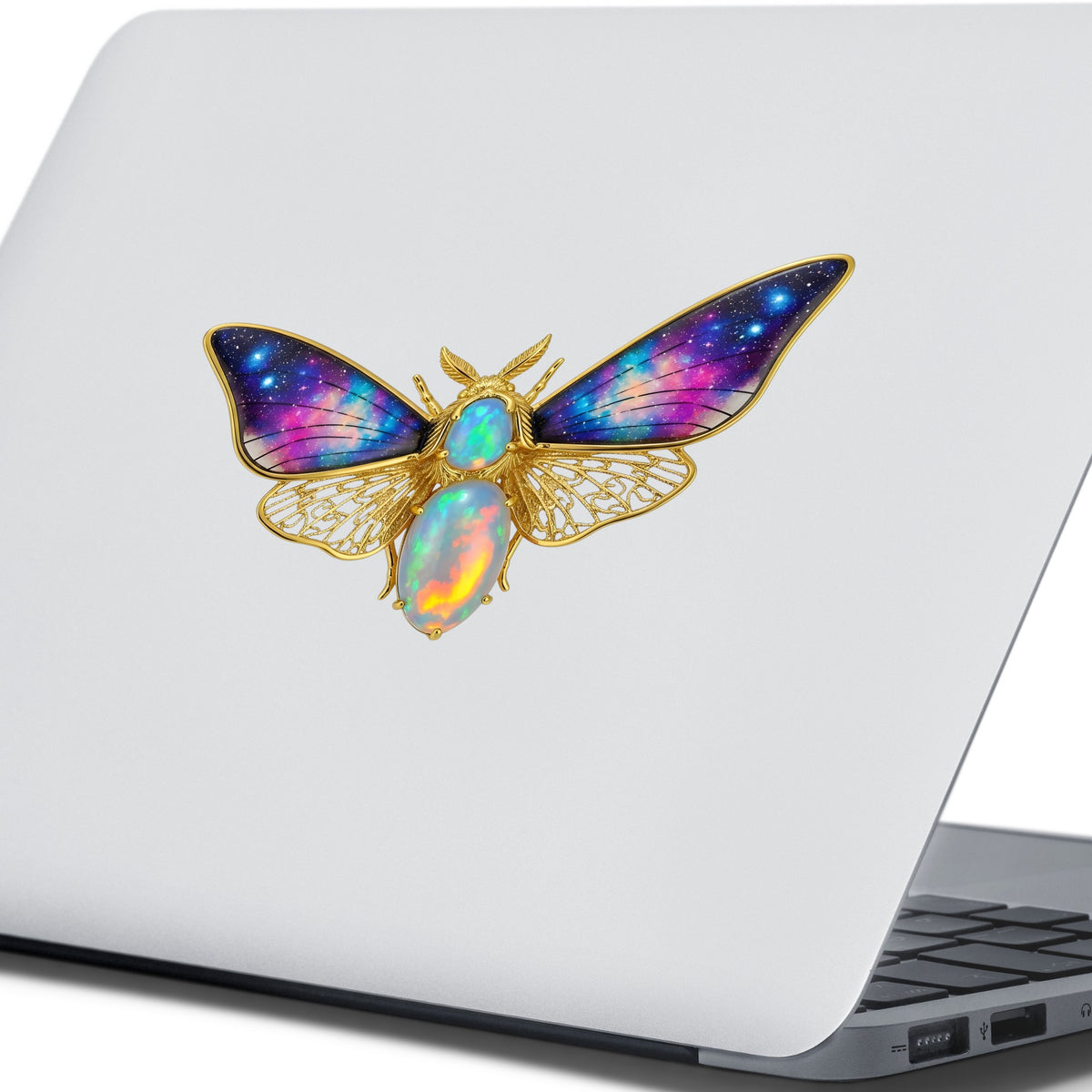 Opal Galaxy Moth UV DTF sticker applied to the lid of a silver laptop