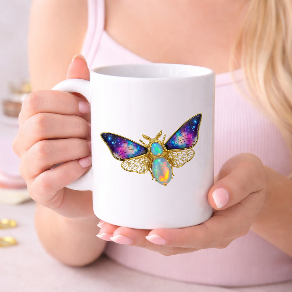 Opal Galaxy Moth UV DTF sticker applied to a white coffee mug held in both hands