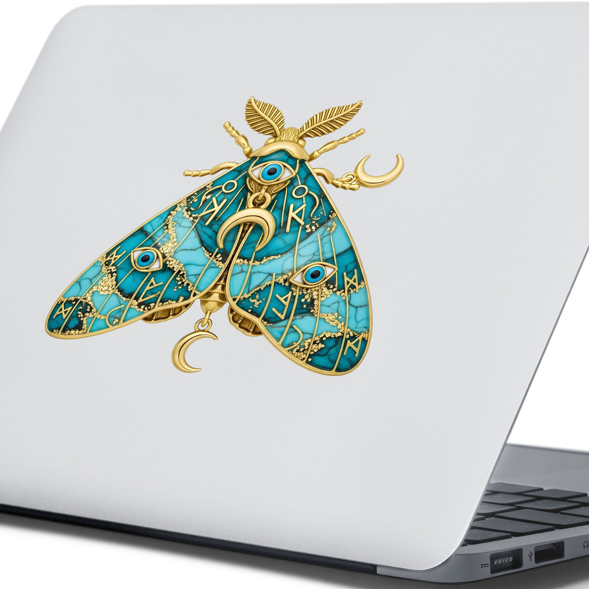 Teal Evil Eye Moth UV DTF sticker applied to the lid of a silver laptop