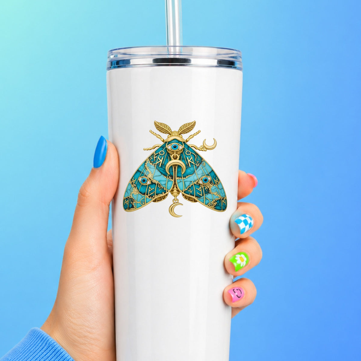Teal Evil Eye Moth UV DTF sticker applied to a white straw tumbler on a blue background