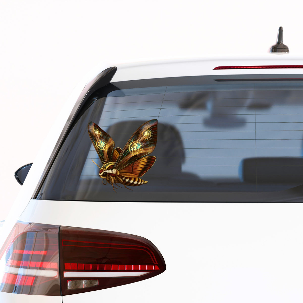 Brown Hawk Moth Glowing Runes UV DTF sticker applied to the rear window of a white car