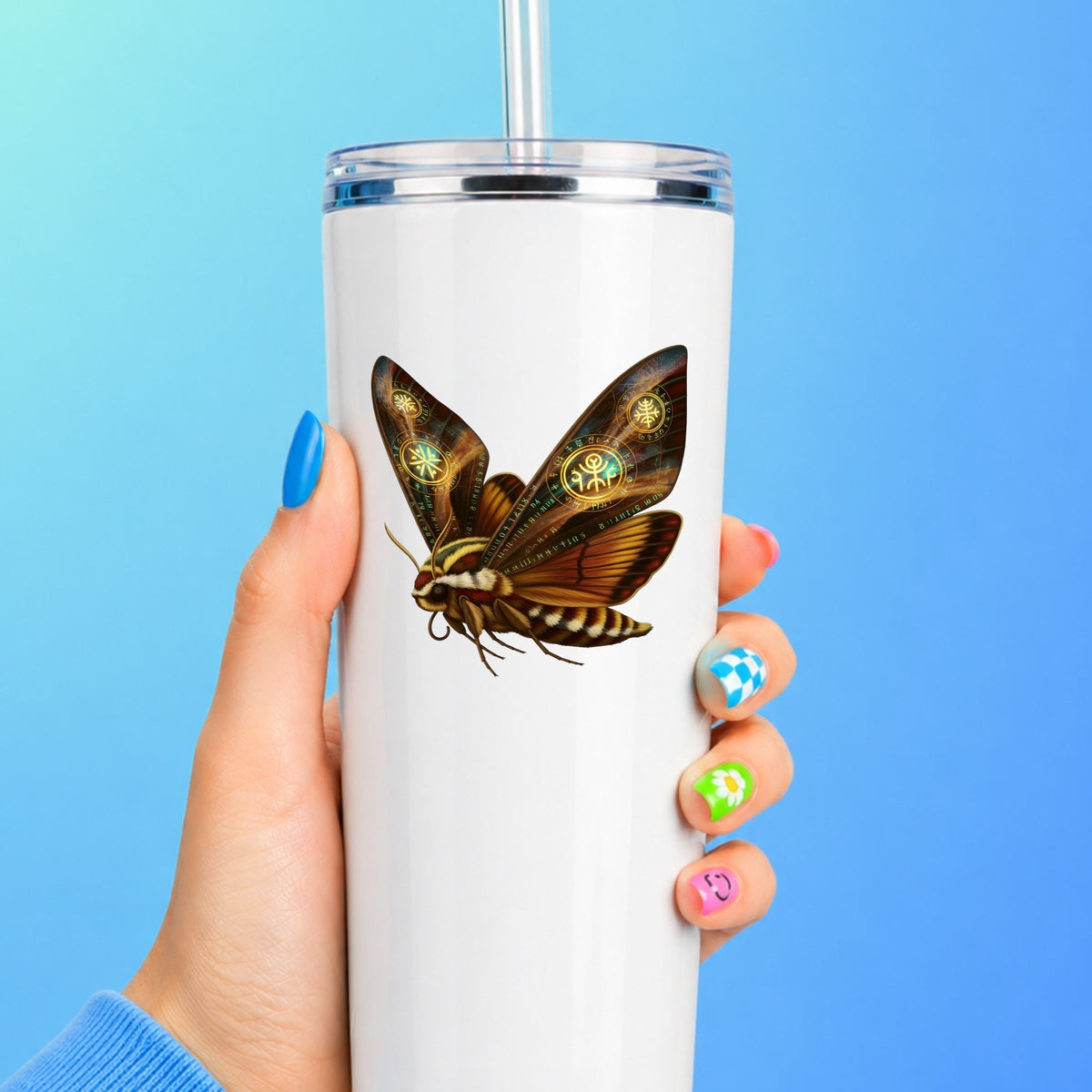 Brown Hawk Moth Glowing Runes UV DTF sticker applied to a white straw tumbler on a blue background