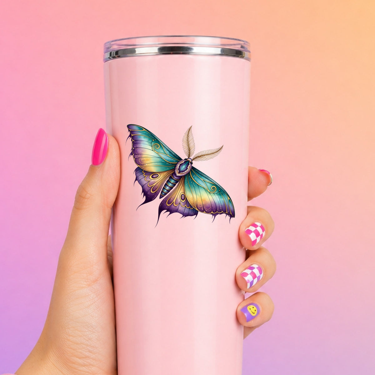 Watercolor Purple Teal Moth UV DTF sticker applied to a tall pink tumbler on a pink and orange background