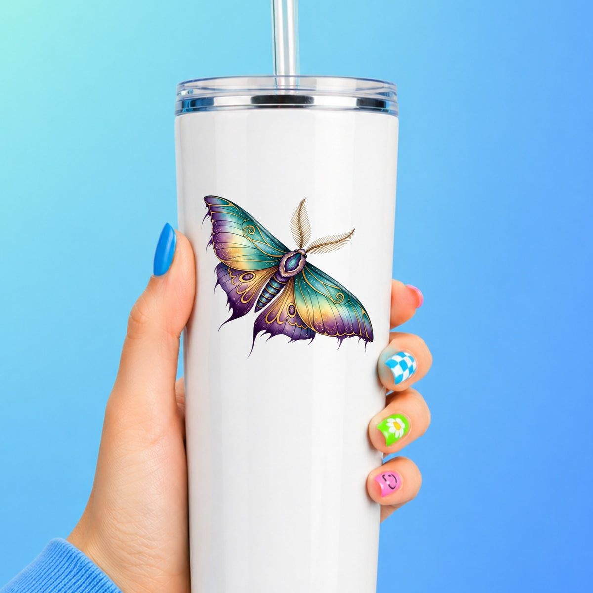 Watercolor Purple Teal Moth UV DTF sticker applied to a white straw tumbler on a blue background