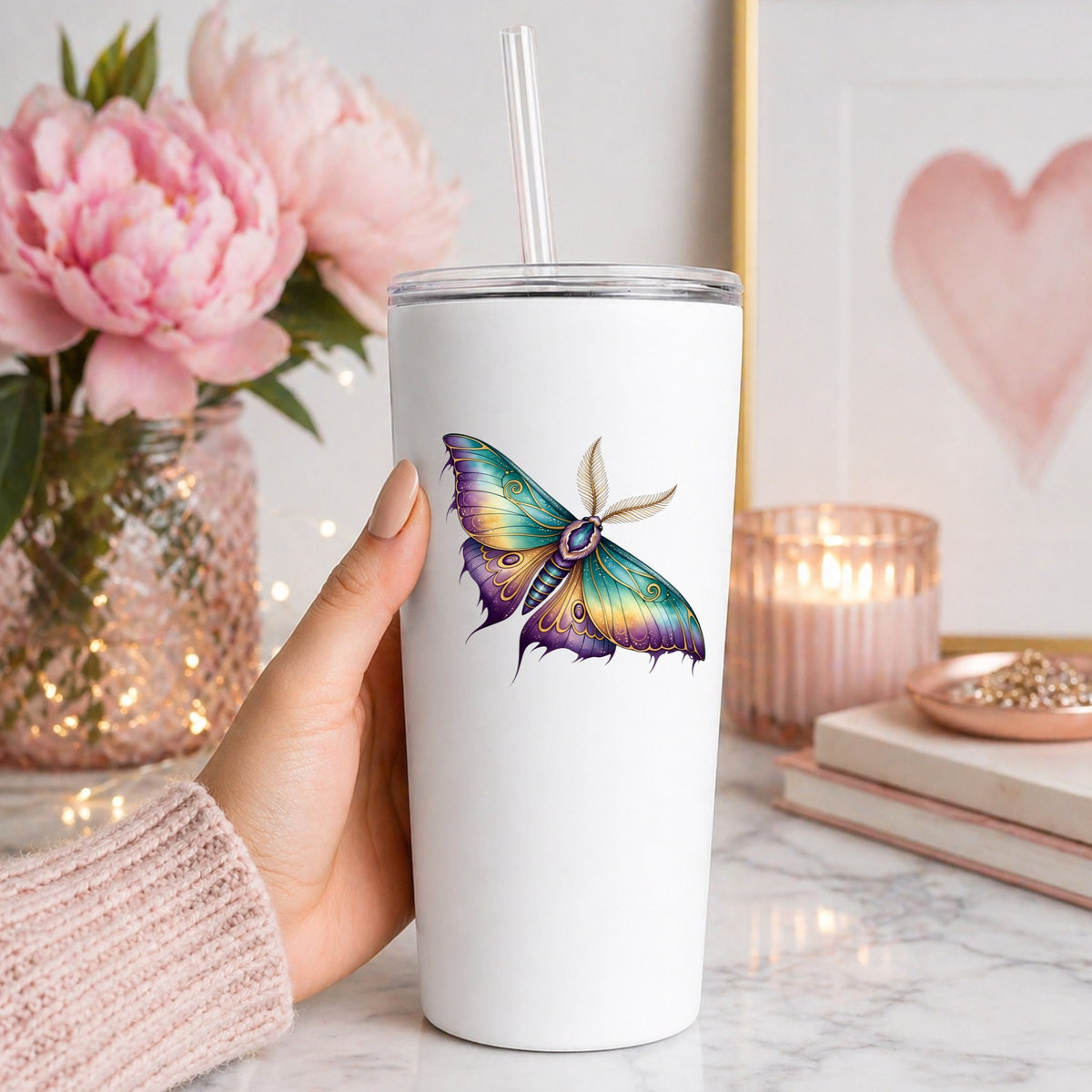 Watercolor Purple Teal Moth UV DTF sticker applied to a white straw tumbler beside pink peonies