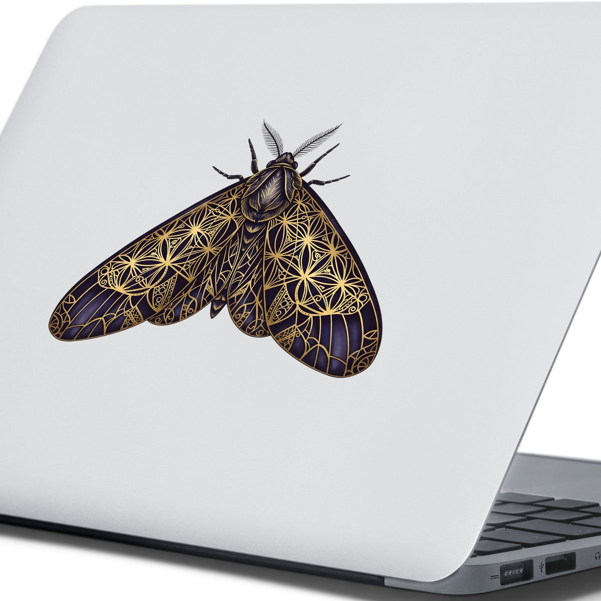 Sacred Geometry Moth UV DTF sticker applied to the lid of a silver laptop