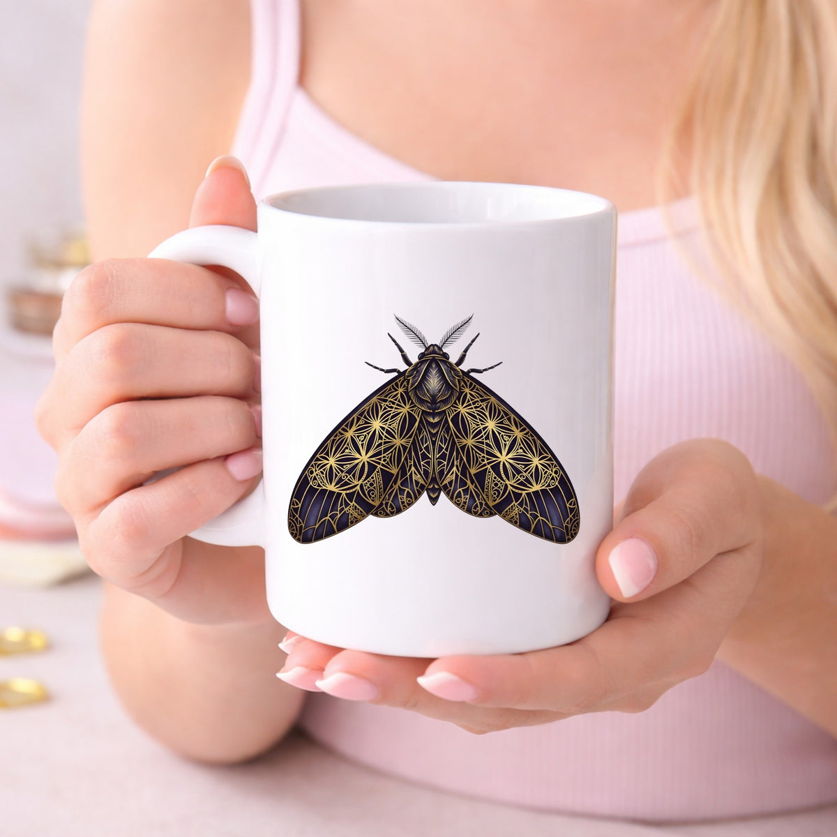 Sacred Geometry Moth UV DTF sticker applied to a white coffee mug held in both hands
