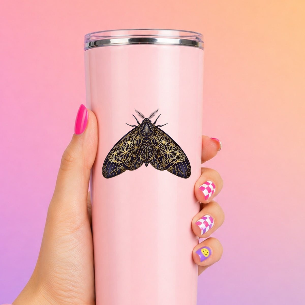 Sacred Geometry Moth UV DTF sticker applied to a tall pink tumbler on a pink and orange background