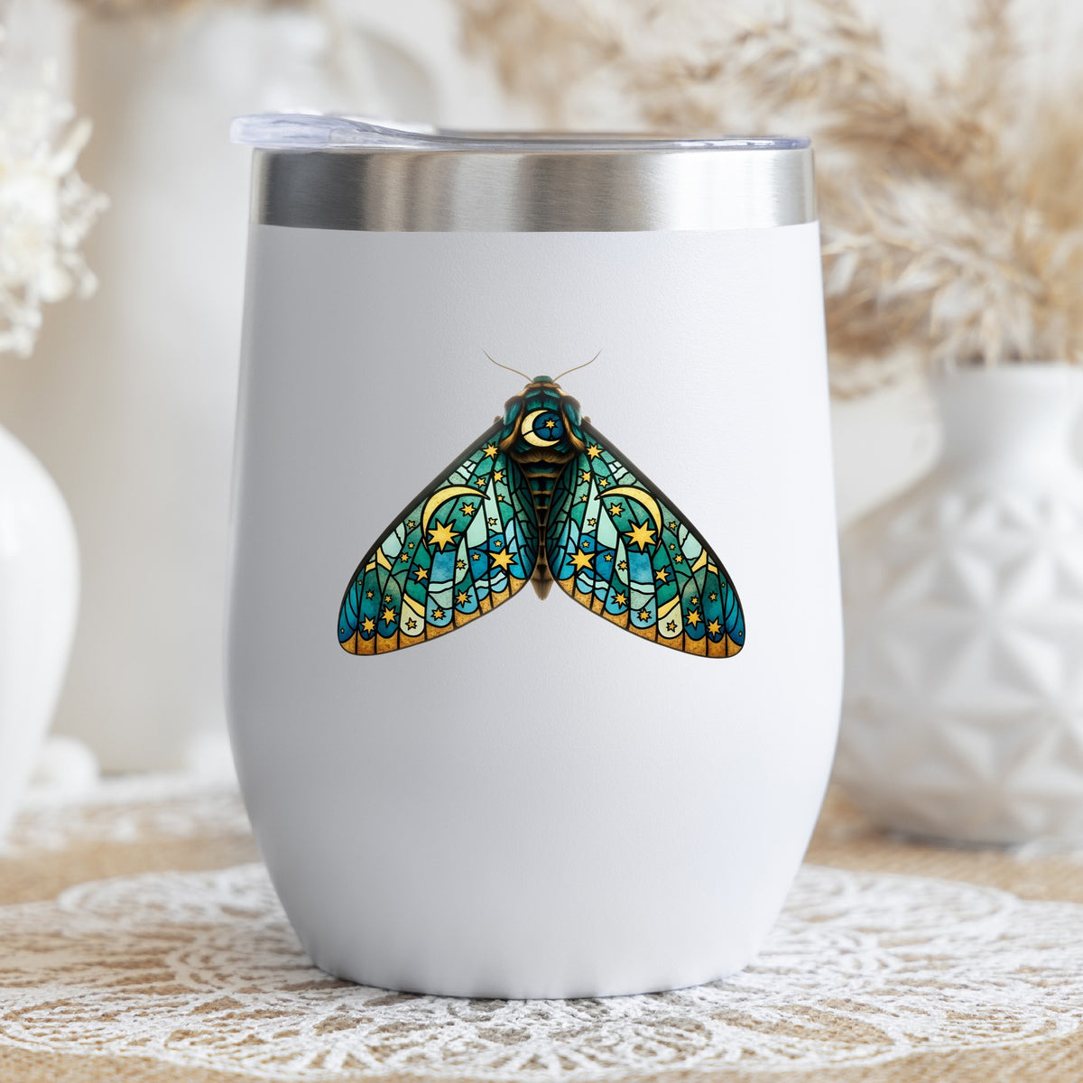 Stained Glass Moon Moth UV DTF sticker applied to a white stemless tumbler with a lid