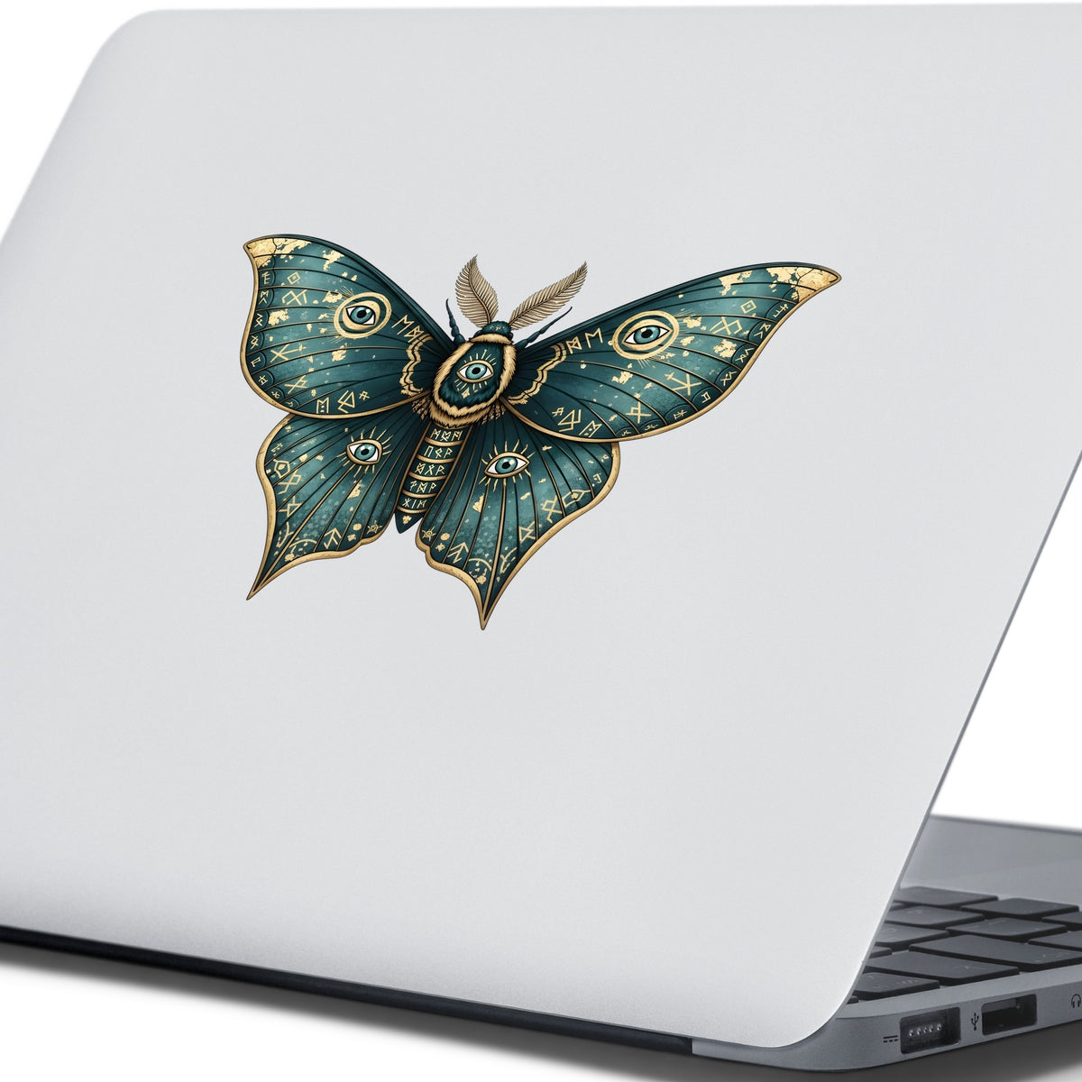 Teal Rune Moth All Seeing Eye UV DTF sticker applied to the lid of a silver laptop