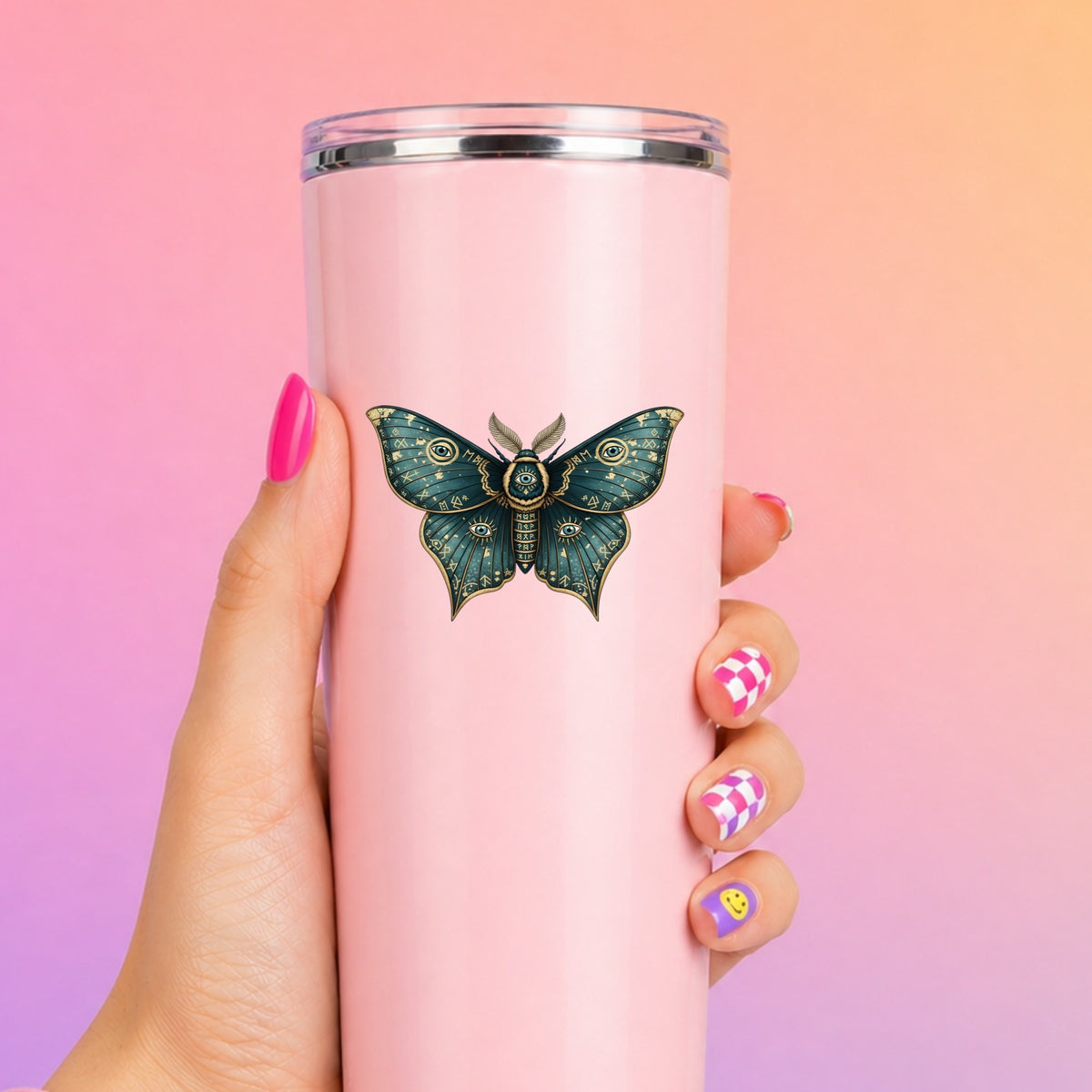 Teal Rune Moth All Seeing Eye UV DTF sticker applied to a tall pink tumbler on a pink and orange background