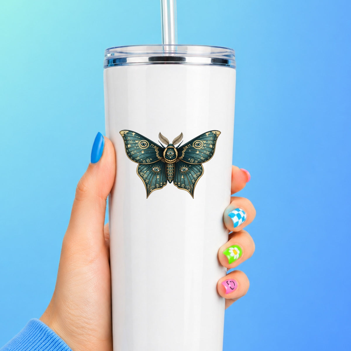 Teal Rune Moth All Seeing Eye UV DTF sticker applied to a white straw tumbler on a blue background