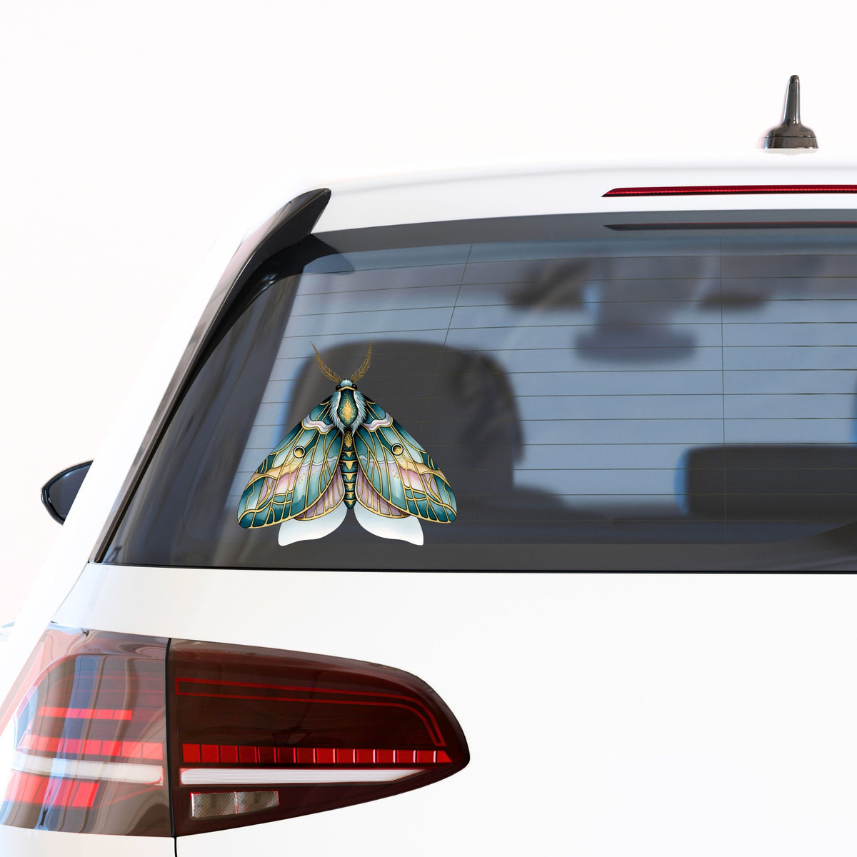 Pastel Teal Pink Moth UV DTF sticker applied to the rear window of a white car