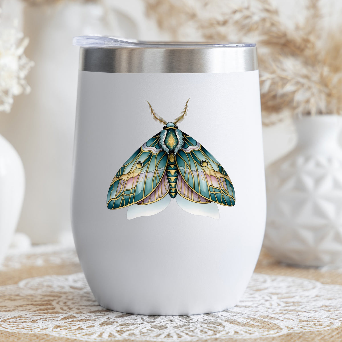 Pastel Teal Pink Moth UV DTF sticker applied to a white stemless tumbler with a lid