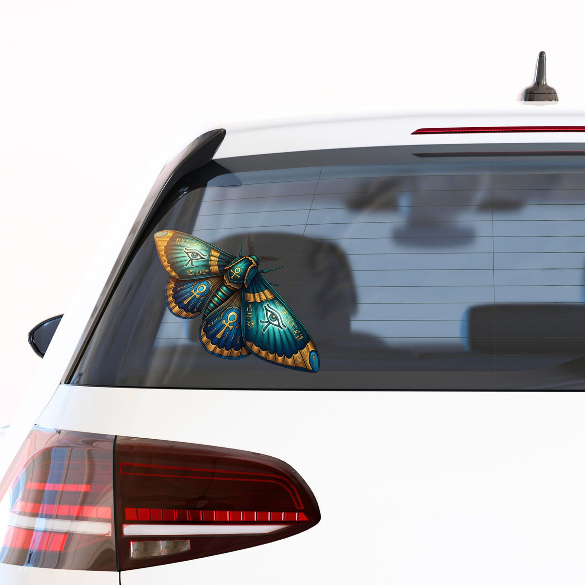 Egyptian Eye Of Horus Moth UV DTF sticker applied to the rear window of a white car