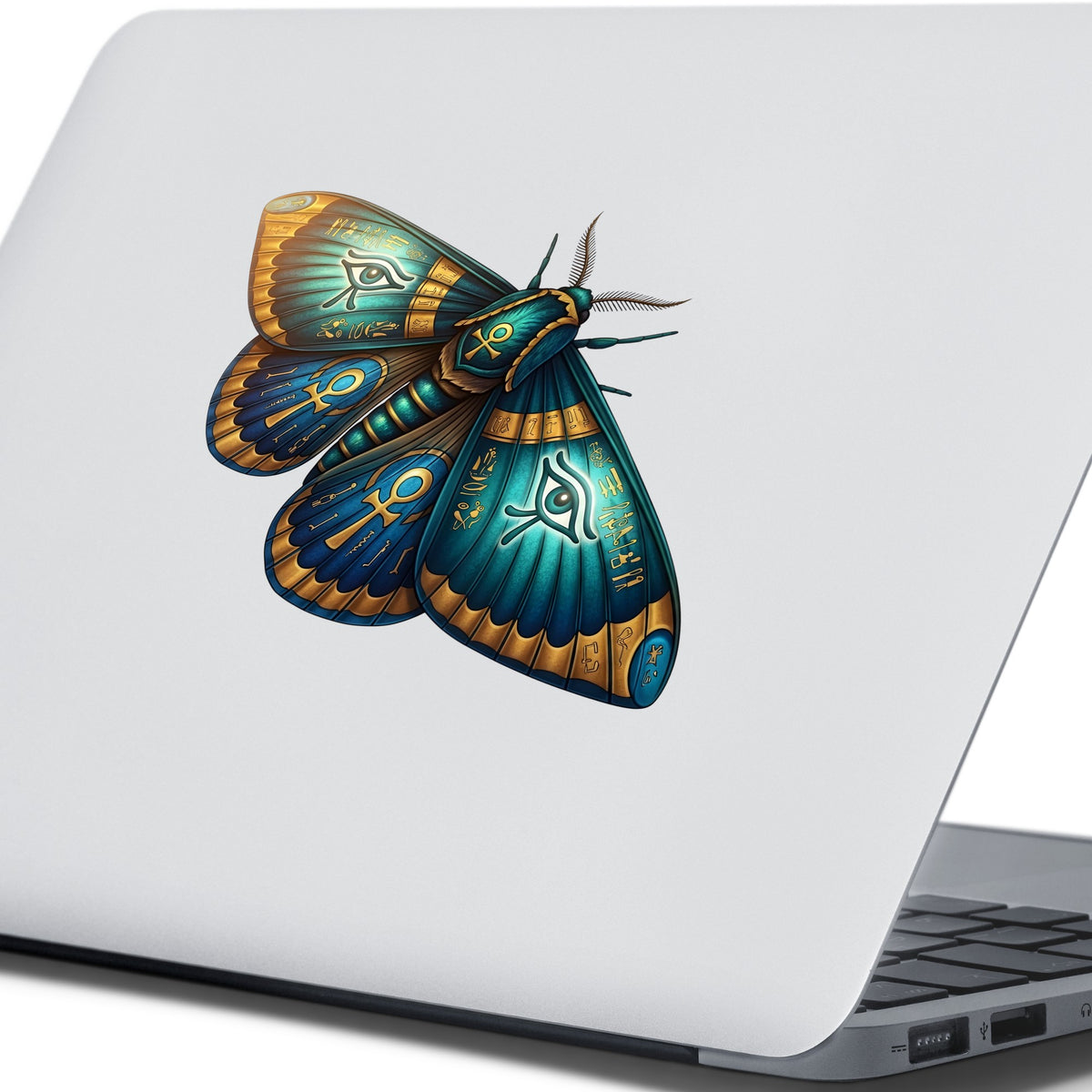 Egyptian Eye Of Horus Moth UV DTF sticker applied to the lid of a silver laptop