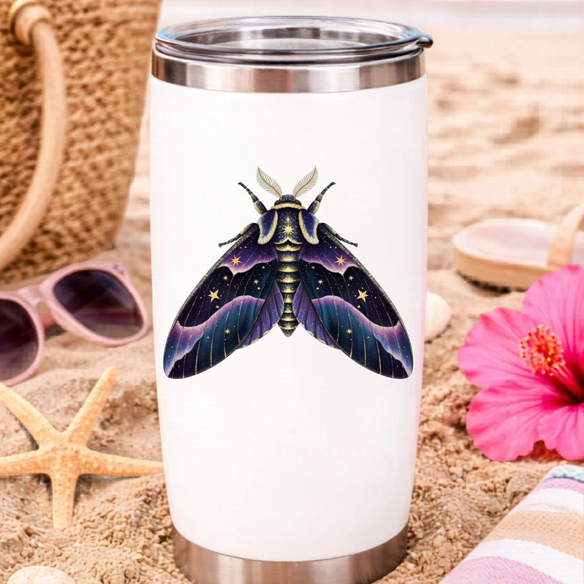Night Sky Purple Moth UV DTF sticker applied to a white travel tumbler on beach sand