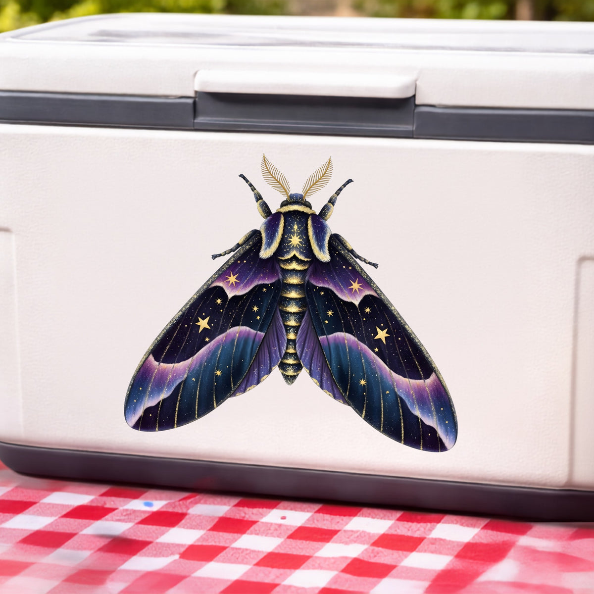 Night Sky Purple Moth UV DTF sticker applied to a white cooler on a red gingham cloth