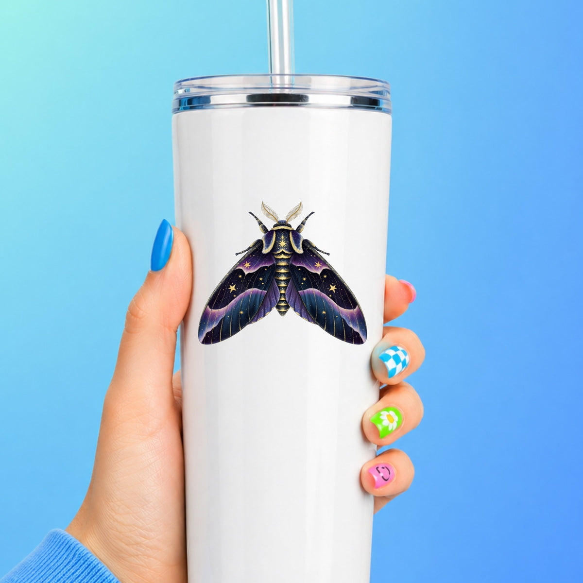 Night Sky Purple Moth UV DTF sticker applied to a white straw tumbler on a blue background