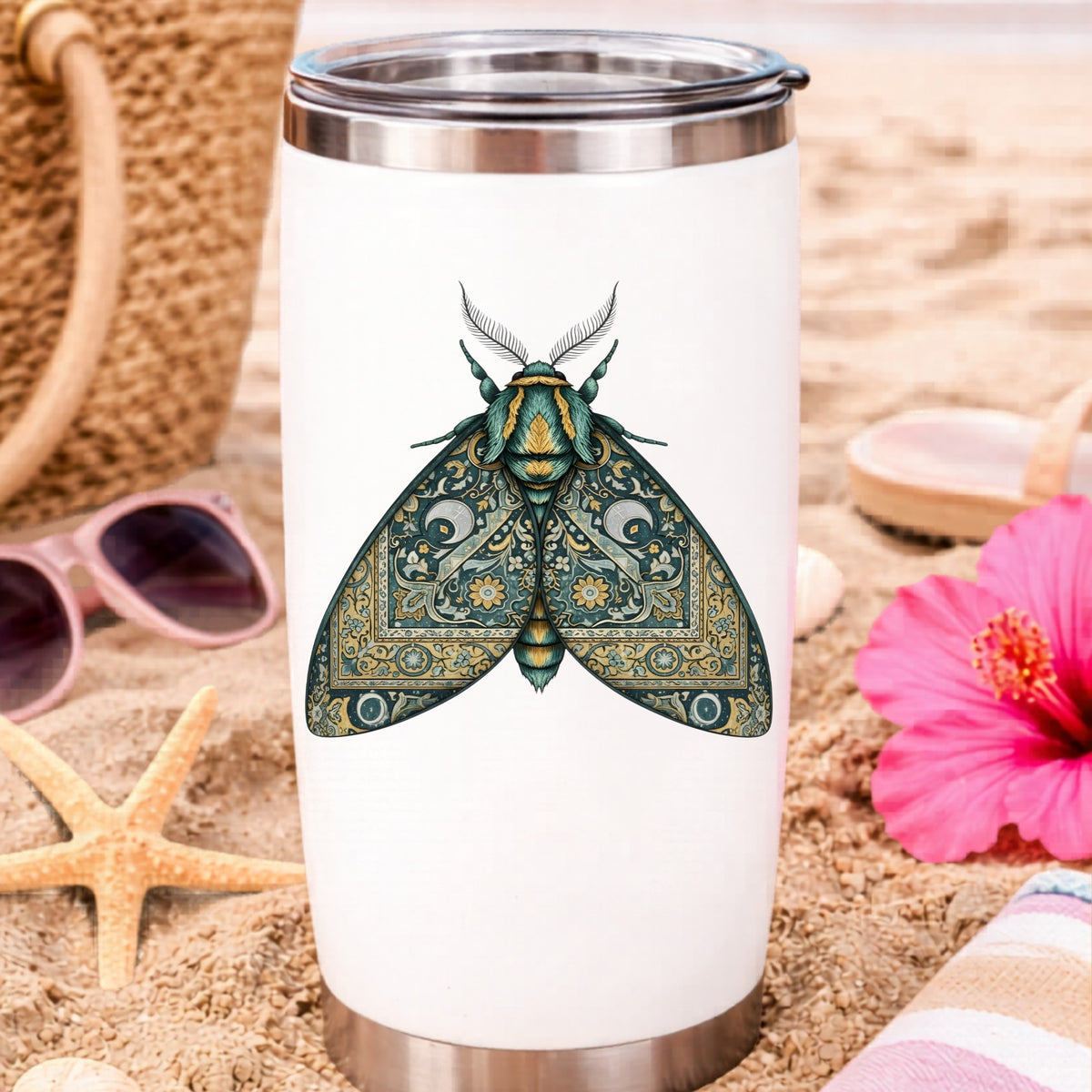 Green Damask Moth UV DTF sticker applied to a white travel tumbler on beach sand
