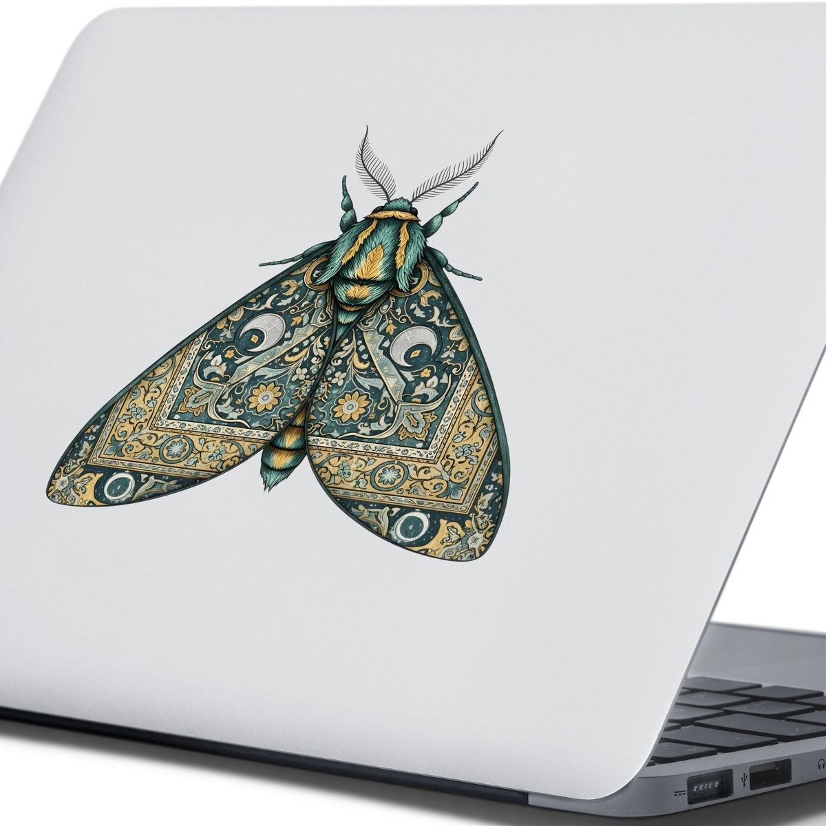 Green Damask Moth UV DTF sticker applied to the lid of a silver laptop