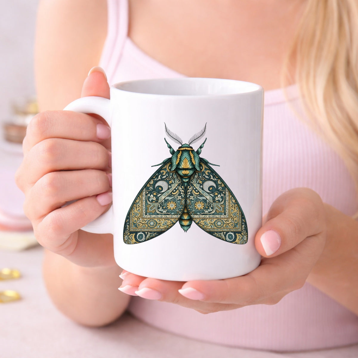 Green Damask Moth UV DTF sticker applied to a white coffee mug held in both hands