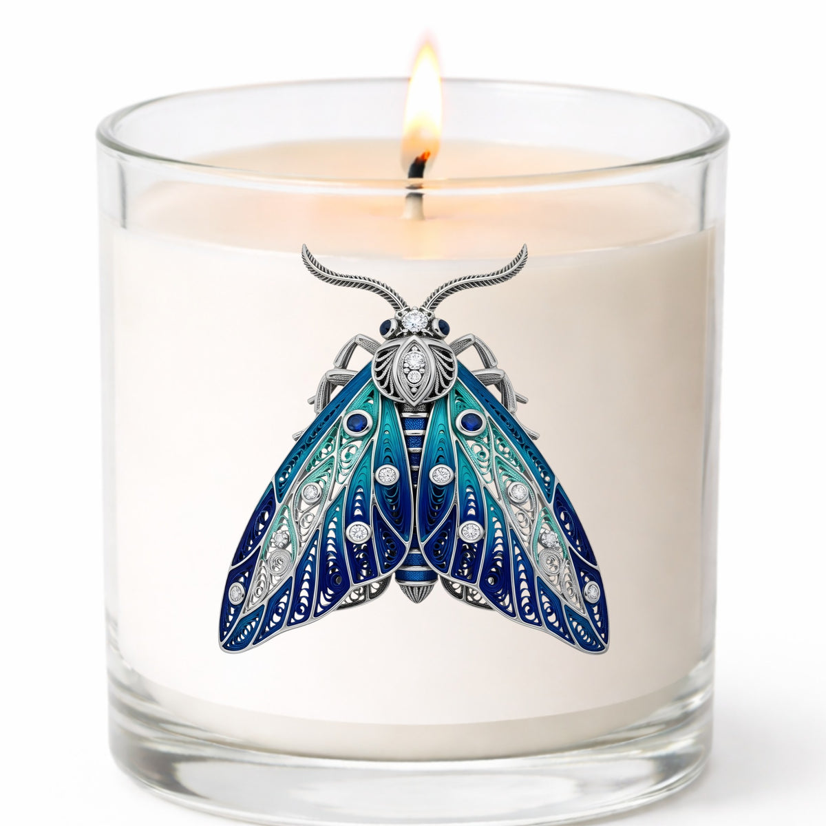 Silver Filigree Blue Moth UV DTF sticker applied to a white candle in a clear glass jar