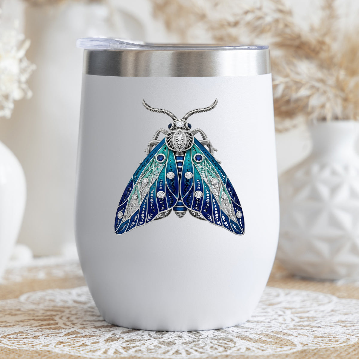 Silver Filigree Blue Moth UV DTF sticker applied to a white stemless tumbler with a lid