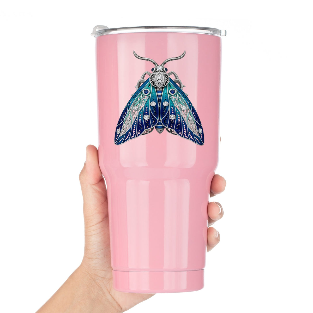 Silver Filigree Blue Moth UV DTF sticker applied to a pink tumbler held against a white background