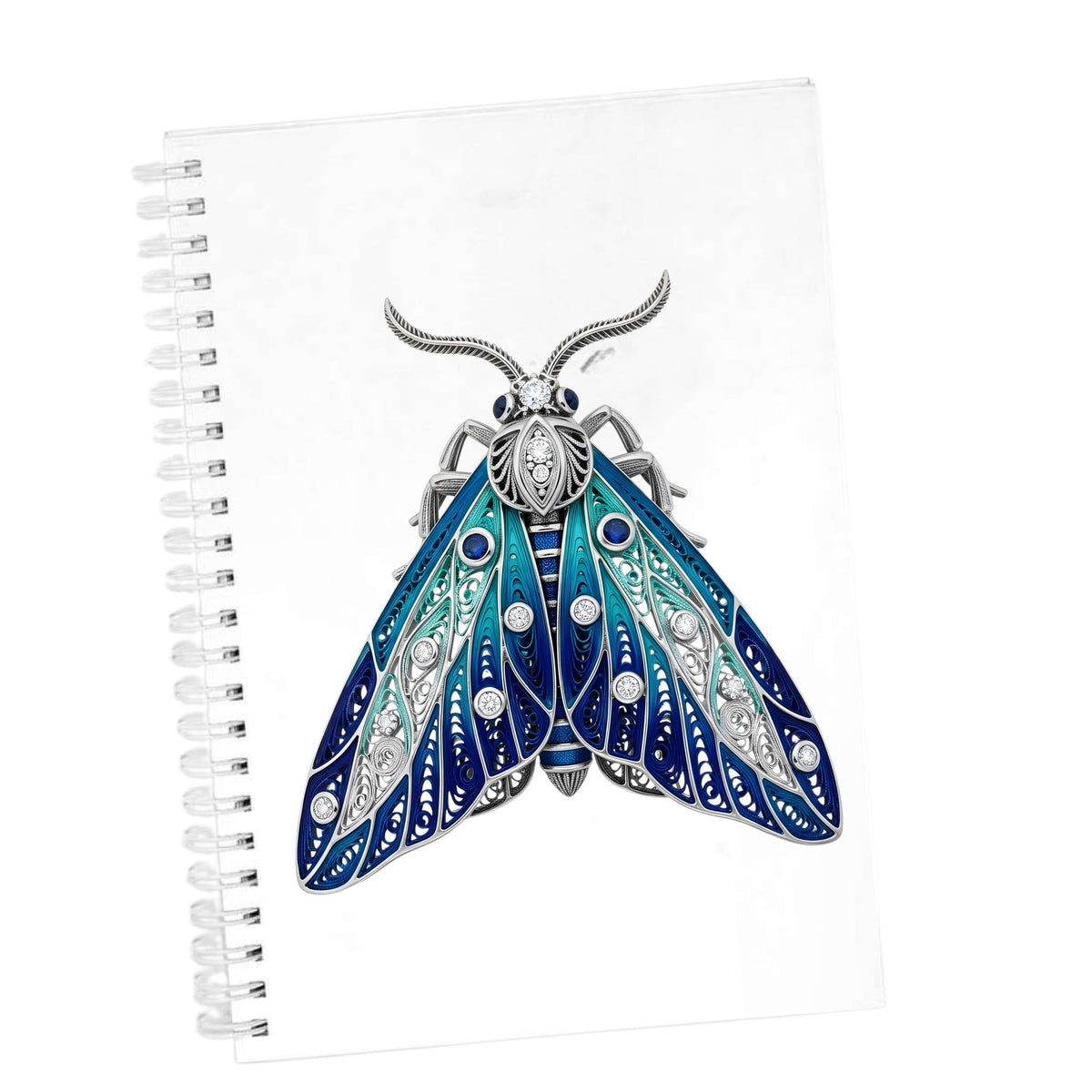Silver Filigree Blue Moth UV DTF sticker applied to the cover of a white spiral journal