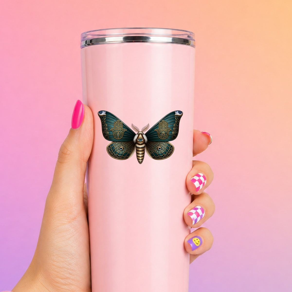Hamsa Hand Moth UV DTF sticker applied to a tall pink tumbler on a pink and orange background