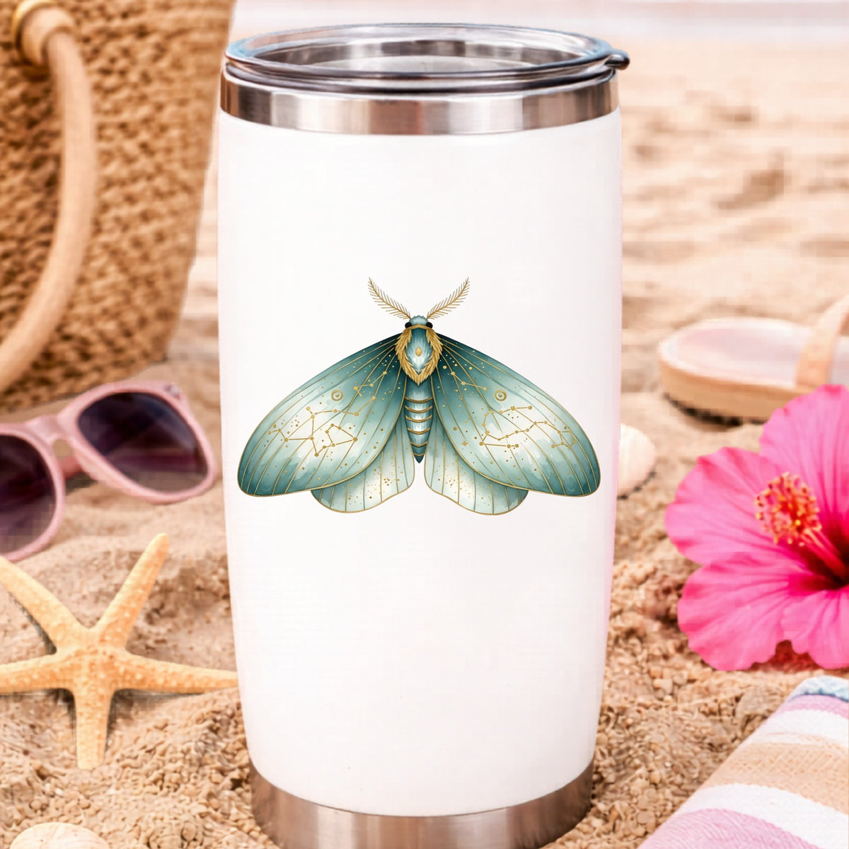 Mint Watercolor Moth UV DTF sticker applied to a white travel tumbler on beach sand
