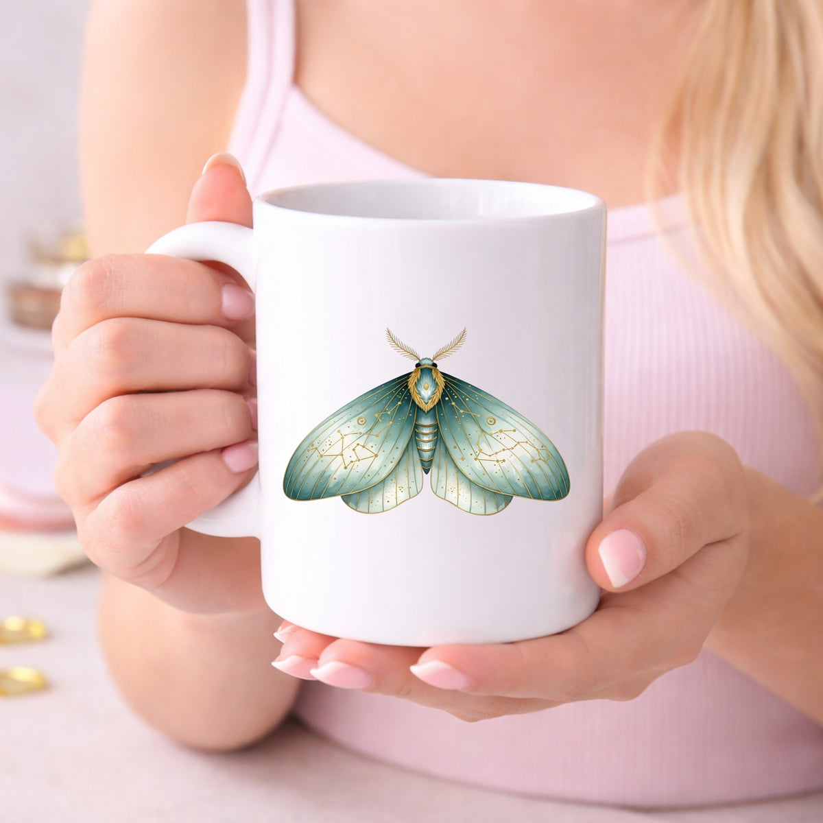 Mint Watercolor Moth UV DTF sticker applied to a white coffee mug held in both hands