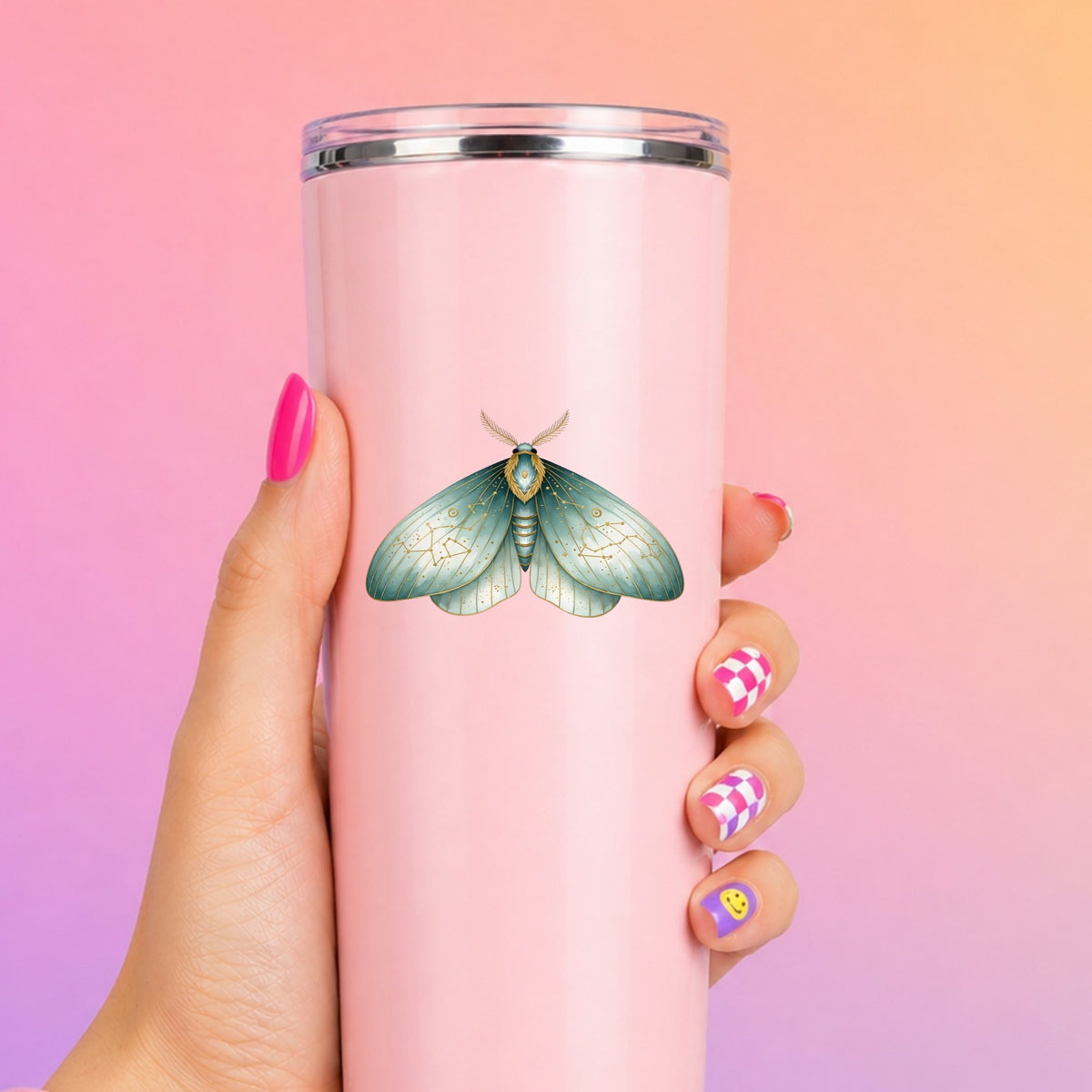 Mint Watercolor Moth UV DTF sticker applied to a tall pink tumbler on a pink and orange background